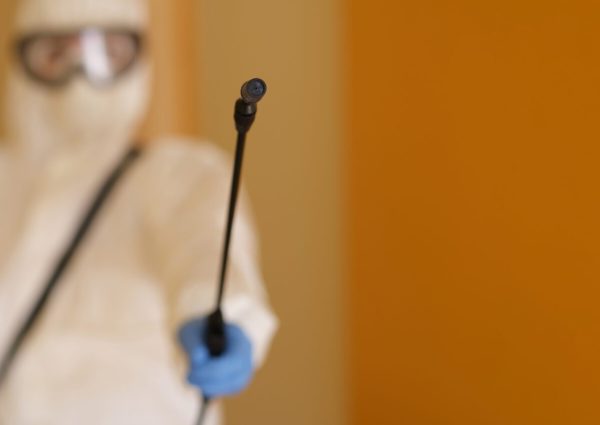Person,In,Protective,Suit,Holding,Disinfection,Equipment,In,Hand Person,In,Protective,Suit,Holding,Disinfection,Equipment,In,Hand