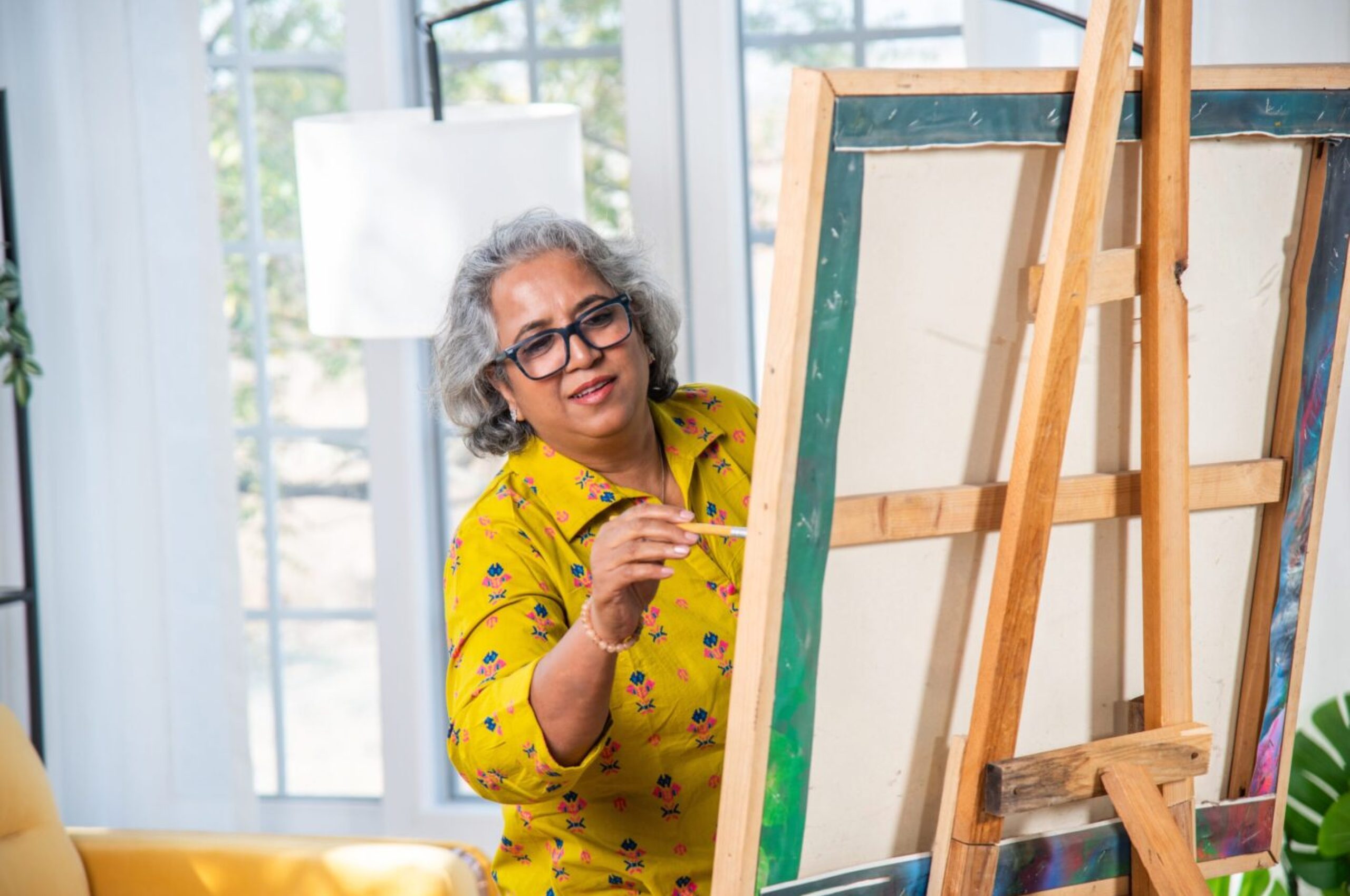 Indian,Senior,Female,Artist,Working,On,Painting,In,Studio,On Indian,Senior,Female,Artist,Working,On,Painting,In,Studio,On